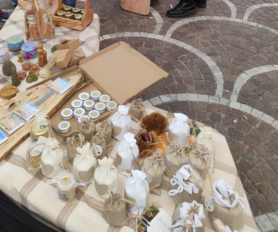 Banco con bomboniere in juta e cotone e cassette di legno con i vasetti